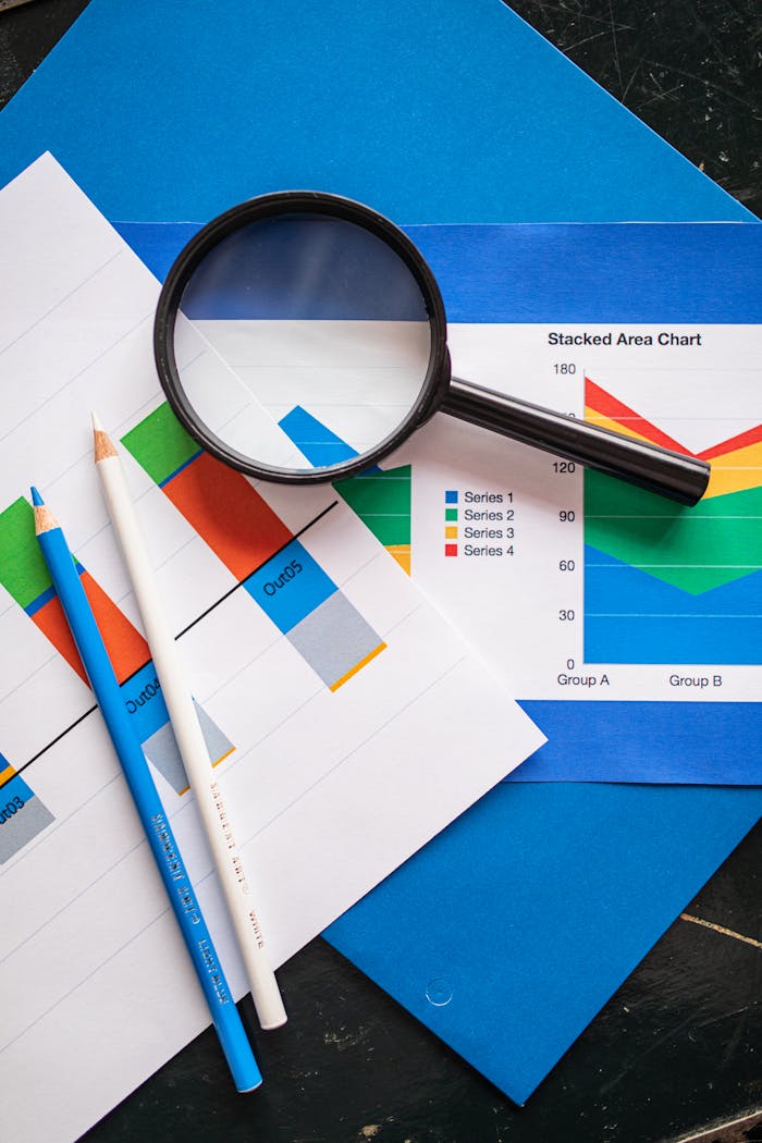 Image of financial charts and magnifying glass, ideal for business insights.